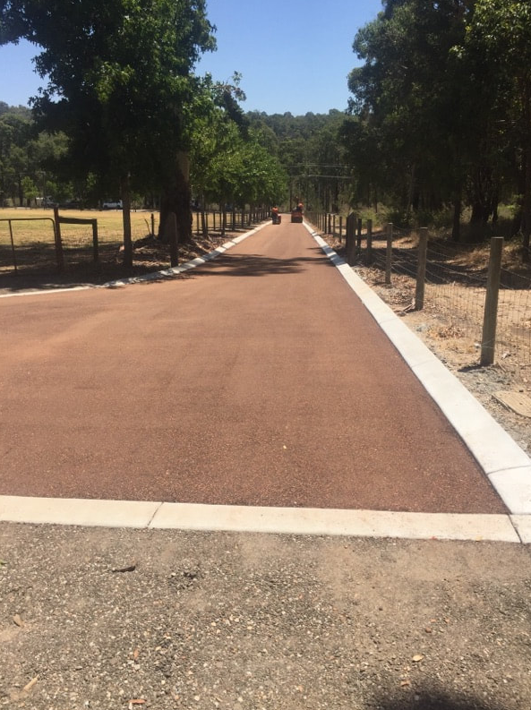 This is a photo of a hot spray & seal bitumen roadway which is in the process of being installed by Little River Road Tech